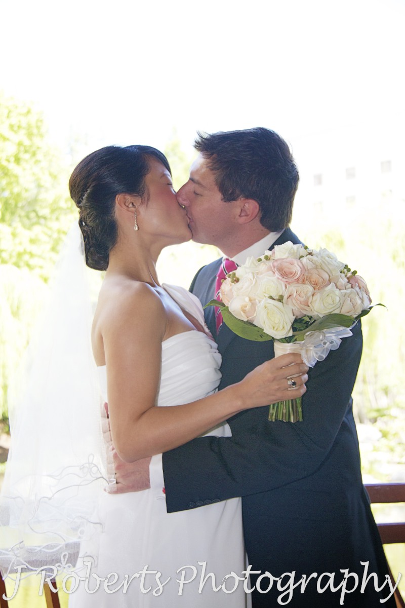 Bride and grooms first kiss as married couple - wedding photography sydney